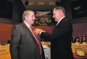 CEO of Limerick City and County Council, Conn Murray, presents Cathaoirleach Kevin Sheahan (FF) with his chain of office at the inaugural meeting