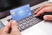 21254381-young-man-sitting-with-laptop-and-credit-card-shopping-online