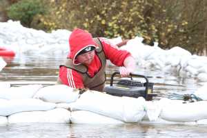 Flooding in East Clare in Springfield, Clonlara where the river Shannon has once agin burst its banks. Philip Quinlivan pictured  draining flood water. Photograph Liam Burke/Press 22