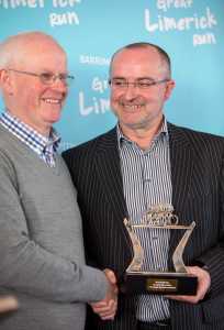 The trophy volunteer: cyclist John Clancy with Barrington's Denis Cahalane Picture: Keith Wiseman