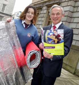 Emily Duffy displaying her 'Duffily Bag' with Enterprise Minister Richard Bruton during the Young Scientist Exhibition.