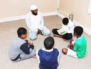 Abdullah Hassan Jaribu listens as a young boy reads from the Koran at the Alfurqan Muslim Community Centre on Windmill Street. Photograph Liam Burke/Press 22