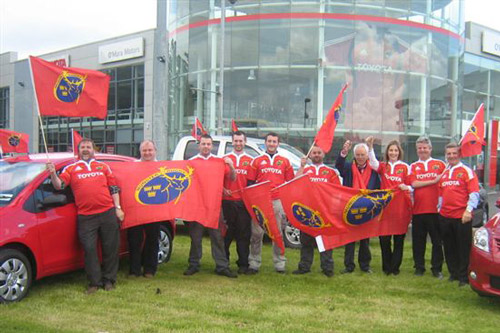 The late Tony O'Mara pictured in a navy jacket, with a Munster Rugby supporters during Toyota's sponsorship of the team. 