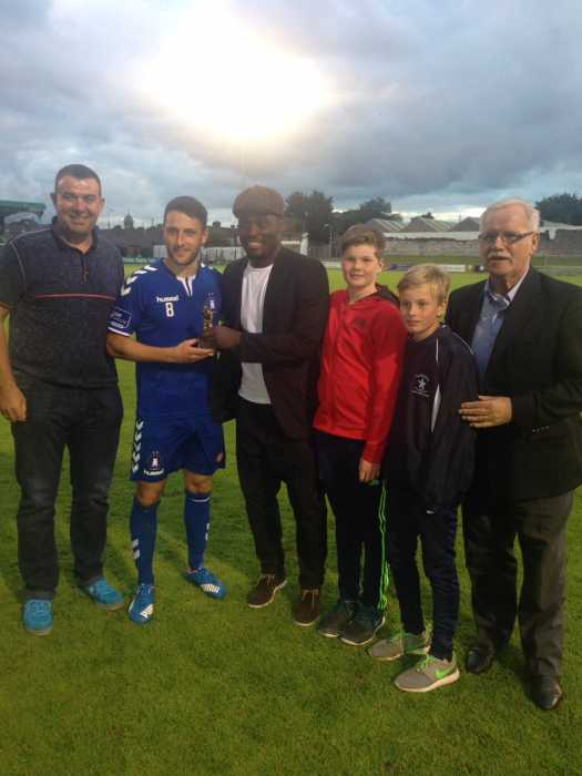 Limerick FC's Shane Duggan is presented with the man of the match award by former Chelsea player Michael Essien.