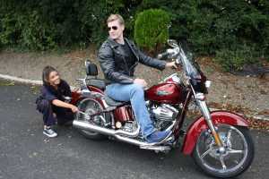 Kate Hurley as Natalie and Gary Keane as Chad astride a Harley-Davison, principal lovers to 'All Shook Up'