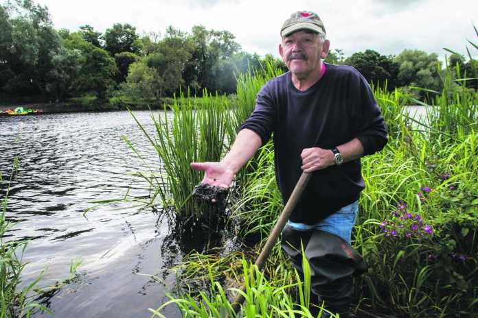 Edward McNamara clearing the the river outside of 'Sleepy Hollow' along the Shannon riverbank. Photo: Cian Reinhardt