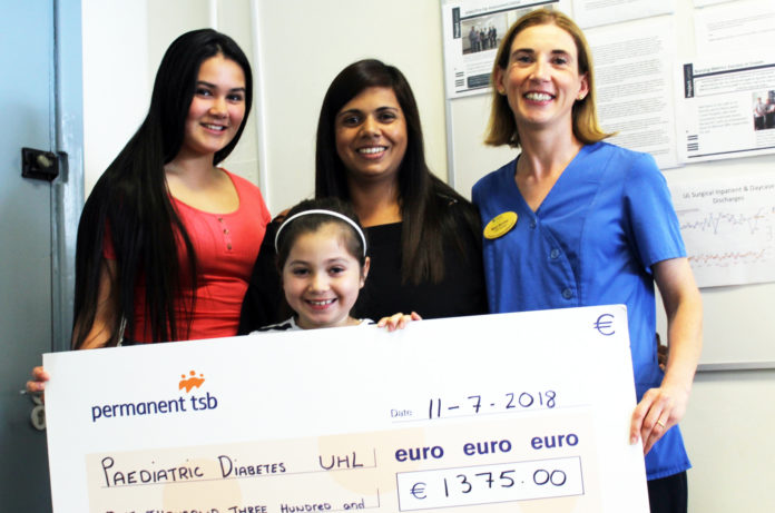 Alicia (left) Tara and Lexie OÕCallaghan (front) with Clinical Nurse Specialist Mary Norris accepting the donation from the proceeds of the Great Limerick Run and colours days in Ballingarry NS and Colaiste na Trocaire, Rathkeale