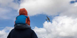 A family watch the Douglas DC-32 pass during the Foynes Airshow. Picture: Sean Curtin True Media.