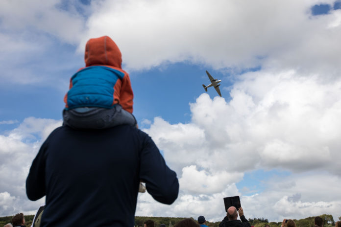 A family watch the Douglas DC-32 pass during the Foynes Airshow. Picture: Sean Curtin True Media.