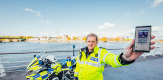 Garda Bryan Duddy displaying the new Garda video app alongside his specially equipped BMW motorbike. Photo: Brian Arthur