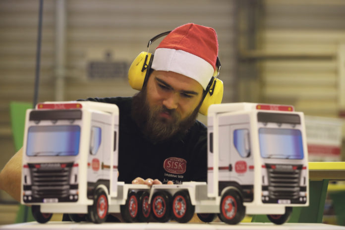 A member of the Sisk carpentry unit putting the finishing touches to toy trucks before dispatch to the Children's Ark at University Hospital Limerick.