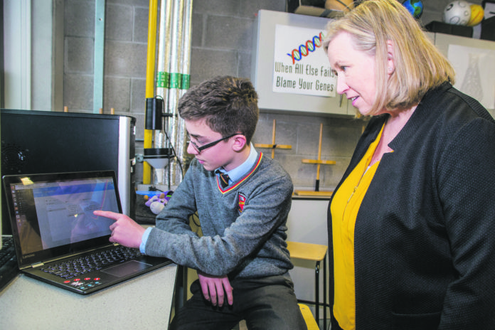 Tag buddy Niall Meade displays his 'Tag Buddy' app to teacher Diane Condon at Ardscoil Rís. Photo: Cian Reinhardt