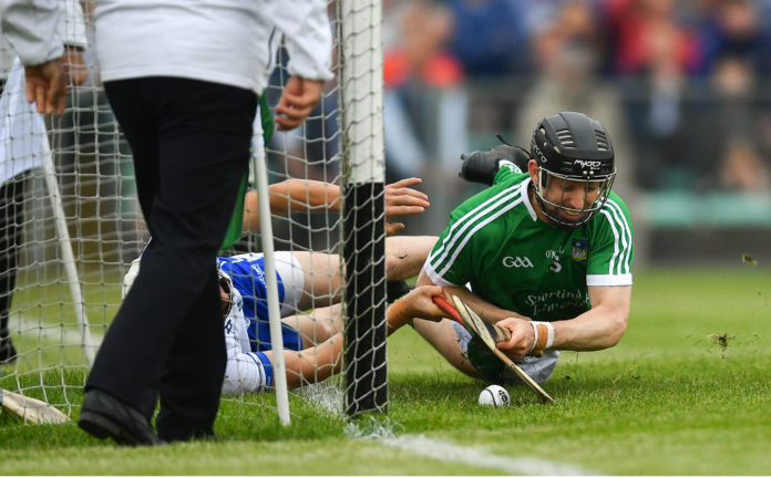 Graeme Mulcahy of Limerick shoots to score his side's second goal of the game despite the attention of Conor Gleeson of Waterford during the Munster GAA Hurling Senior Championship Round 4 match between Limerick and Waterford at the Gaelic Grounds in Limerick. Photo by Ramsey Cardy/Sportsfile