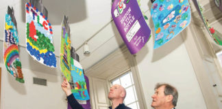 Paul O'Connell and JP McManus looking over some of the entries at the 'Design a TLC Bottle' prizegiving in the Hunt Museum Photo: Diarmuid Greene