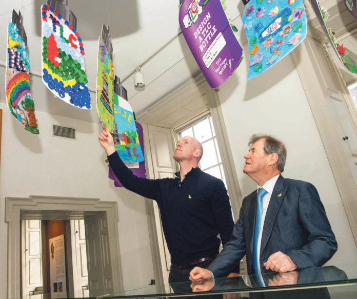 Paul O'Connell and JP McManus looking over some of the entries at the 'Design a TLC Bottle' prizegiving in the Hunt Museum Photo: Diarmuid Greene