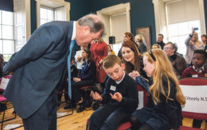 Eli O'Sullvian works out a maths question put to him by JP McManus, alongside senior infant student Carla O'Brien and teacher Charlotte Reidy at the 'Design a TLC Bottle' prizegiving ceremony. Photo: Diarmuid Greene