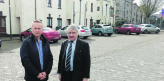 Local election candidate Christy McInerney and Depuy Willie O'Dea utside the houses in Convent Street.