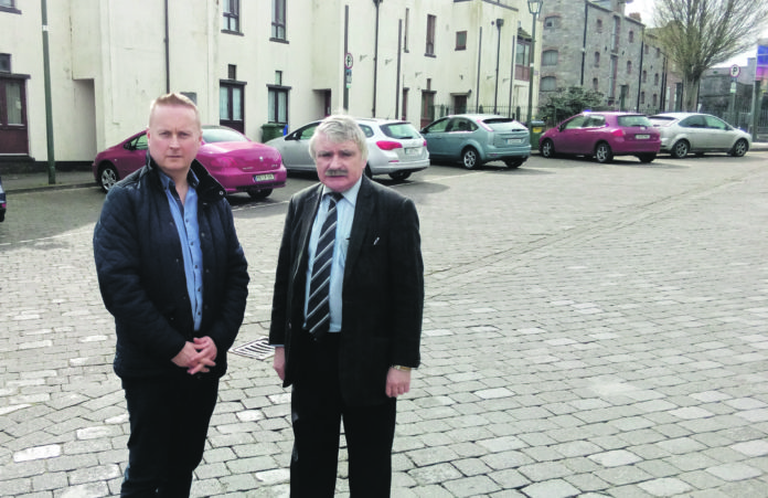 Local election candidate Christy McInerney and Depuy Willie O'Dea utside the houses in Convent Street.