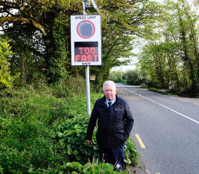 Michael Murphy at the speed activated traffic sign at Nelson's Cross