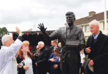 Fr Johnny Daly blessing the JFK statue in Bruff under the watchful eye of Michael Fitzgerald. Photo: Brendan Gleeson