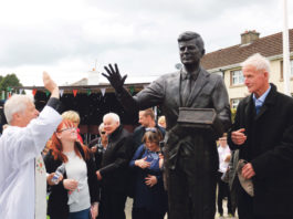 Fr Johnny Daly blessing the JFK statue in Bruff under the watchful eye of Michael Fitzgerald. Photo: Brendan Gleeson