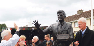 Fr Johnny Daly blessing the JFK statue in Bruff under the watchful eye of Michael Fitzgerald. Photo: Brendan Gleeson