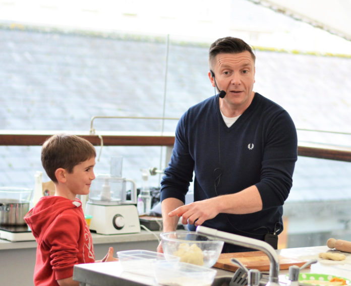 Paul Knapp passing on his cookery skills to the next generation.