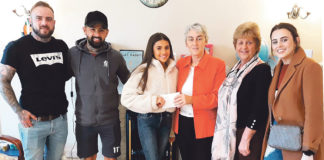 Kate Yeung presenting the proceeds of her fund-raising tattoo session to Sr Helen Culhane of the Children’s Grief Centre with the tattooists and supporters who helped her organise the event.