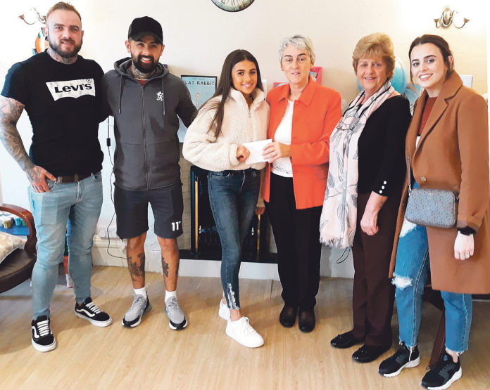 Kate Yeung presenting the proceeds of her fund-raising tattoo session to Sr Helen Culhane of the Children’s Grief Centre with the tattooists and supporters who helped her organise the event.