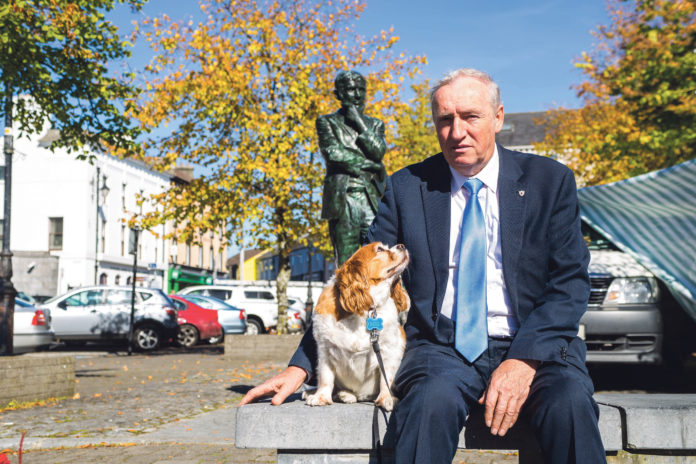 Pat O'Donovan pictured with Breezy in front of the Michael Hertnett Statue in Newcastle West Town Square. Photo: Cian Reinhardt
