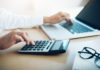Finances Saving Economy concept. Female accountant or banker use calculator. money