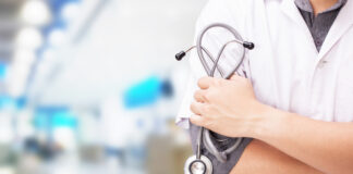 Doctor with a stethoscope in the hands and hospital background