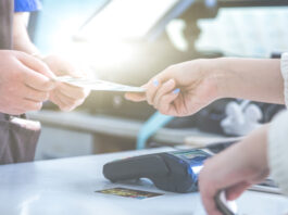 cash and card payment with chip and pin machine in shop. retail