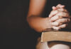 Christian life crisis prayer to god. Woman Pray for god blessing to wishing have a better life. woman hands praying to god with the bible. begging for forgiveness and believe in goodness.