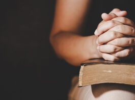 Christian life crisis prayer to god. Woman Pray for god blessing to wishing have a better life. woman hands praying to god with the bible. begging for forgiveness and believe in goodness.