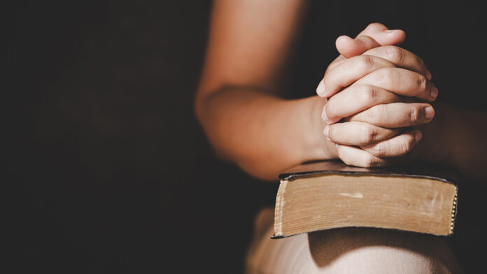 Christian life crisis prayer to god. Woman Pray for god blessing to wishing have a better life. woman hands praying to god with the bible. begging for forgiveness and believe in goodness.