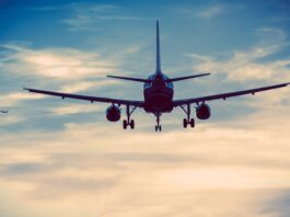 Commercial Airplanes on the Sky. Urban Blue Color Grading. Air Transportation Concept.