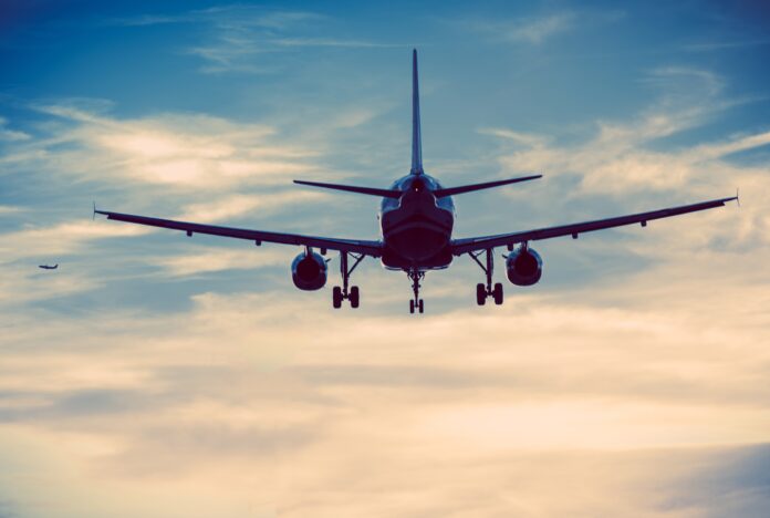 Commercial Airplanes on the Sky. Urban Blue Color Grading. Air Transportation Concept.