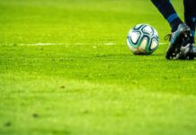 man playing soccer game on field