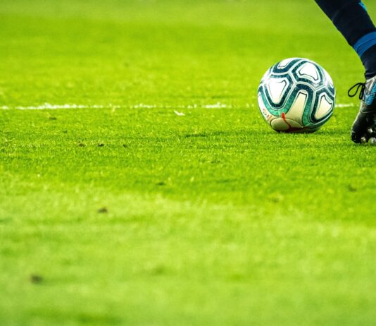 man playing soccer game on field