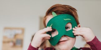 boy holding green mask