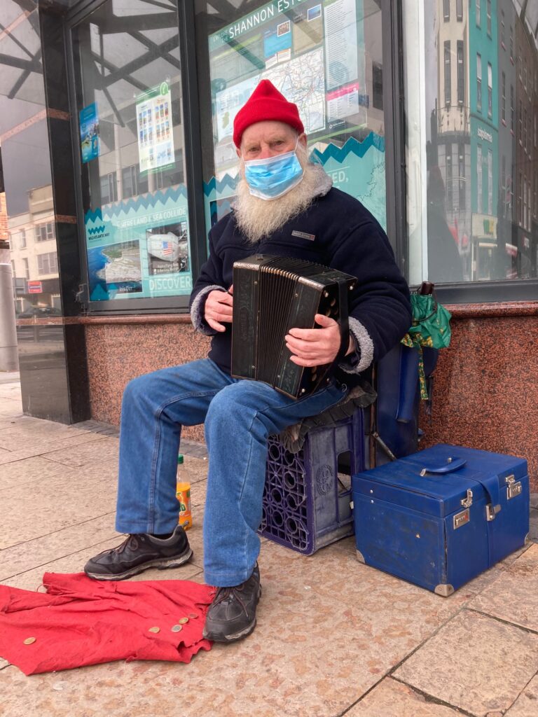 Ireland’s “oldest busker” plays sweet music after receiving first dose of COVID-19 vaccine
