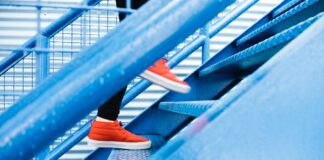 person stepping on blue stairs