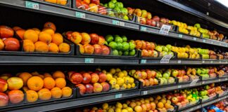 yellow and red apples on black plastic crate