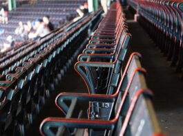 people sitting on red gang chairs