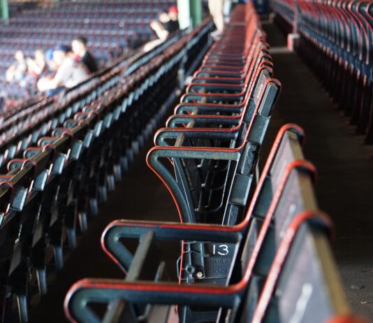 people sitting on red gang chairs