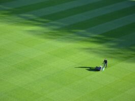 aerial photography of person trimming sports field during day