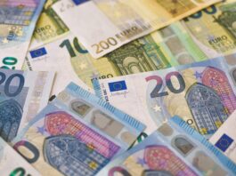 20 euro bill on white and blue textile