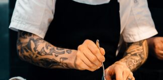 person putting food on plate