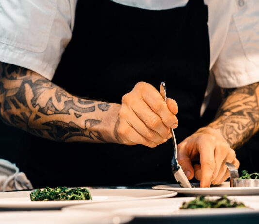 person putting food on plate